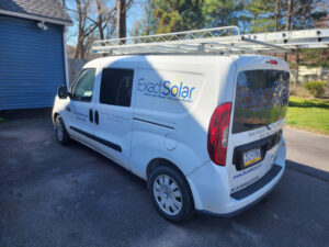 A white work van with the Exact Solar logo.