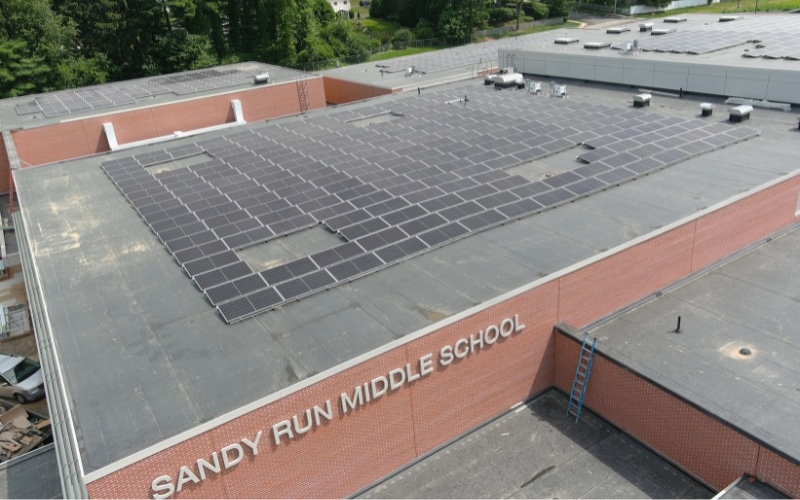 Aerial view of commercial roof-mounted solar system at Sandy Run Middle School in Dresher, Pennsylvania installed by Exact Solar