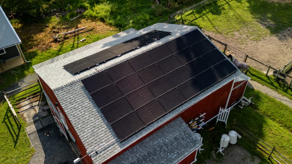 A barn with rooftop solar panels.