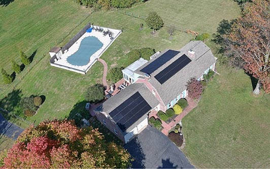 Aerial view of a roof-mounted residential solar system installed by Exact Solar