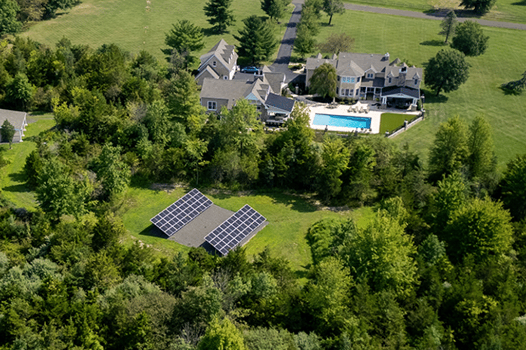 a house with a ground-mounted solar installation