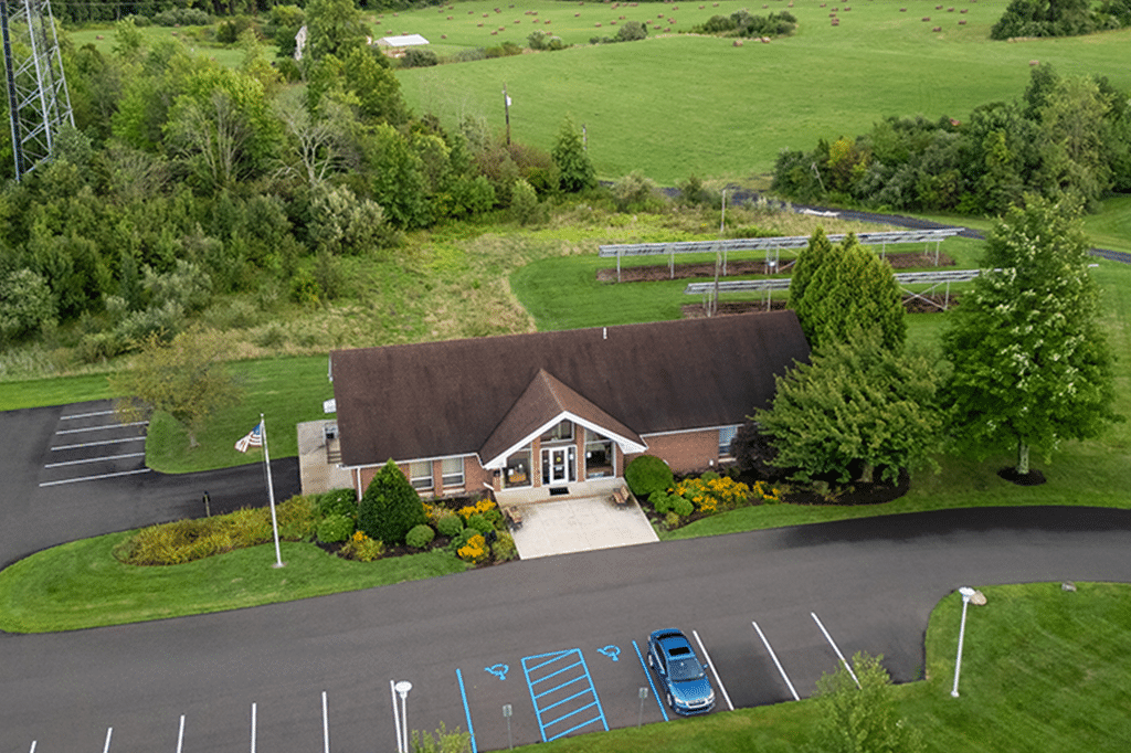 a building with a parking lot and a car in the parking lot