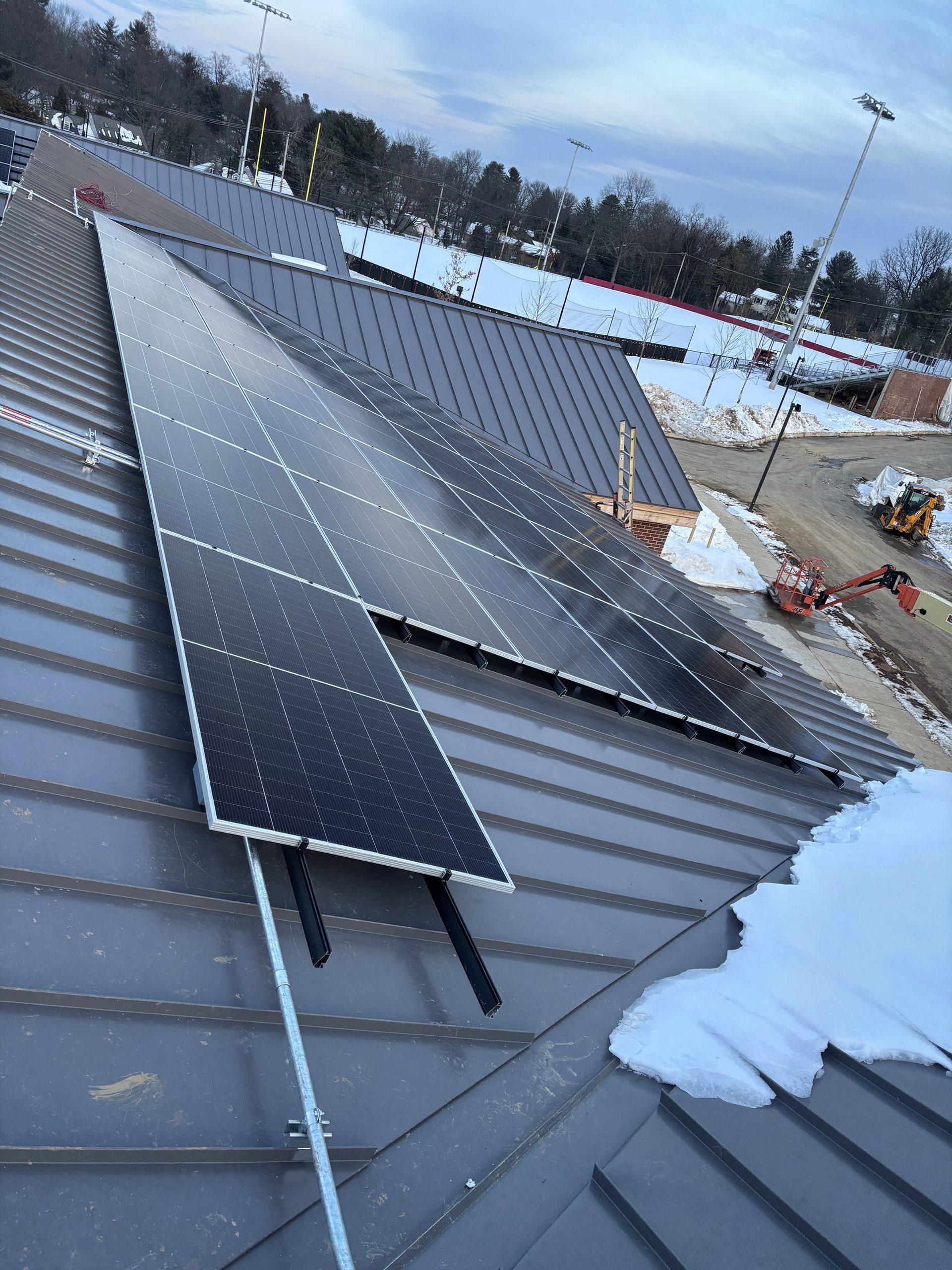 S-5! clamps connect the solar mounting system to the field house’s raised metal seams without drilling through the roofing panels.