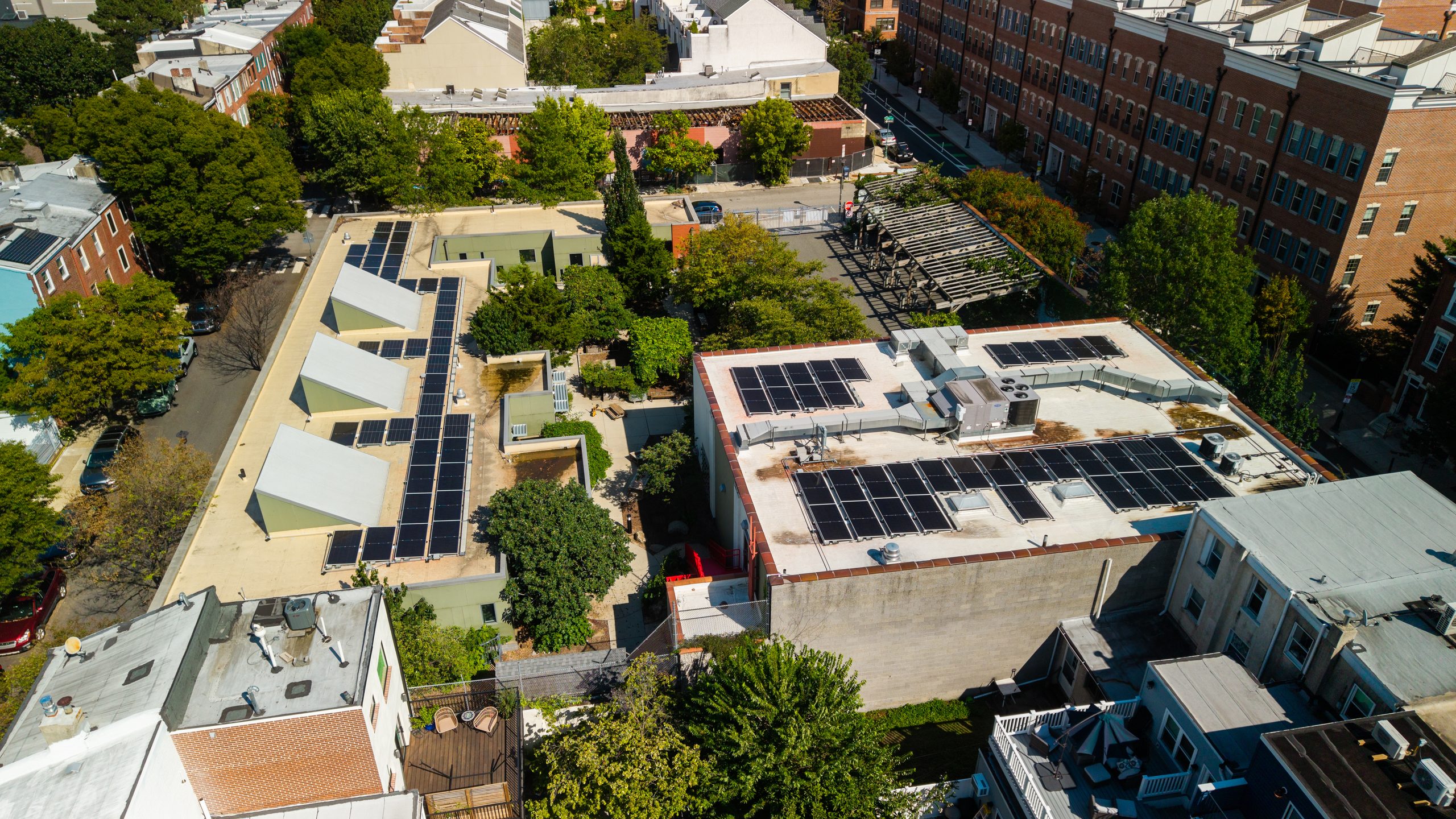 The Philadelphia School’s solar panels alongside the gardens and greenery on its urban campus.